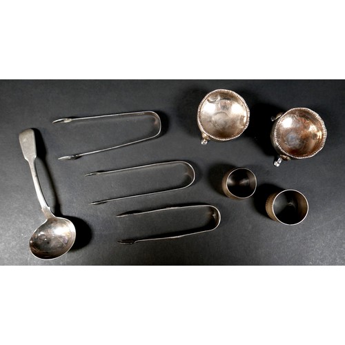 56 - A group of Georgian and later silver items, comprising three pairs of sugar nips, two napkin rings, ... 