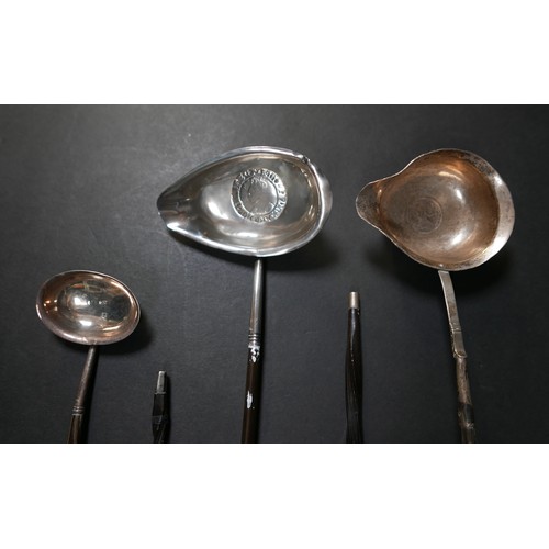 75 - A group of five 18th and 19th century toddy ladles, most with baleen twist handles, one with inset E... 