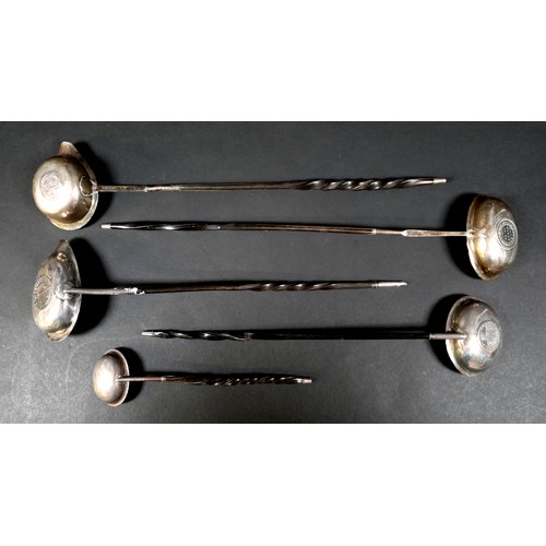 75 - A group of five 18th and 19th century toddy ladles, most with baleen twist handles, one with inset E... 