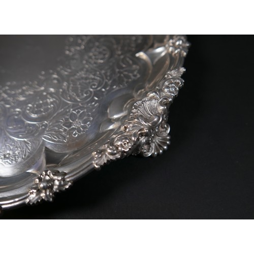 97 - A Georgian silver waiter tray, of circular form with Chippendale pie crust edge, likely later chased... 