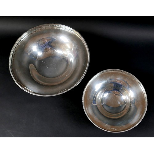 99 - A set of two silver pedestal dishes, each of circular form with pierced gallery, raised on tapering ... 