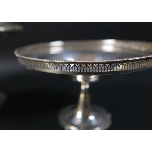 99 - A set of two silver pedestal dishes, each of circular form with pierced gallery, raised on tapering ... 