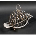 A George III silver six division toast rack, with heart shaped dividers and shell handles, raised on... 