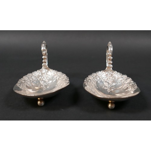51 - A pair of American Sterling silver dishes, early 20th century, the oval bowls cast with trailing flo... 