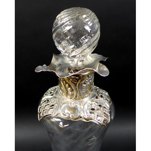 54 - A Victorian decanter and stopper with silver applied scroll work, William Comyns & Sons, London 1904... 
