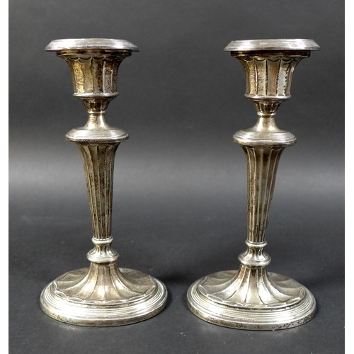 16 - A pair of silver candlesticks, on green leather bases, George Unite & Sons, Birmingham 1902, total w... 
