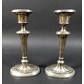 A pair of silver candlesticks, on green leather bases, George Unite & Sons, Birmingham 1902, total w... 