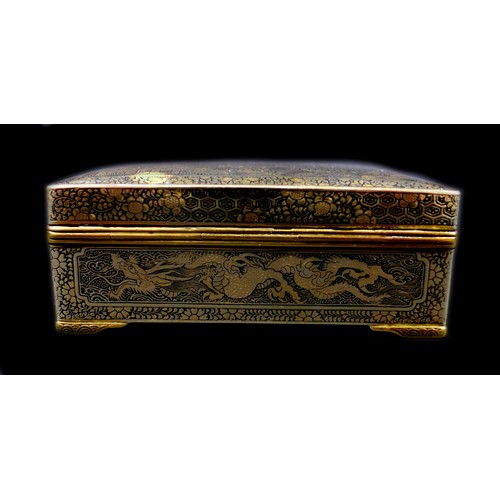 102 - A Japanese Komai type box, with hinged cover and stay chain, the exterior finely decorated in gilt w... 