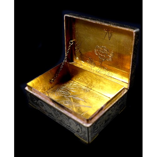 102 - A Japanese Komai type box, with hinged cover and stay chain, the exterior finely decorated in gilt w... 