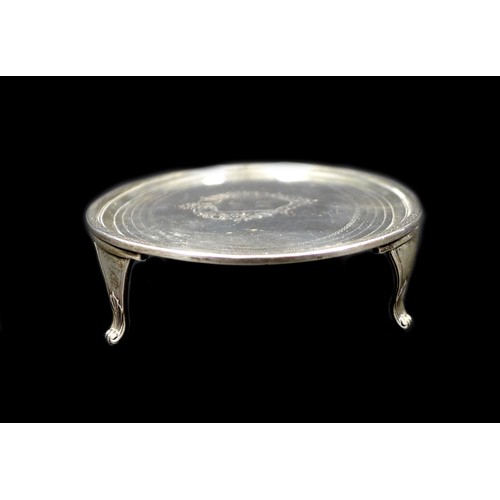 79 - A George III silver teapot stand, of oval form, with engraved wrigglework borders and central foliat... 