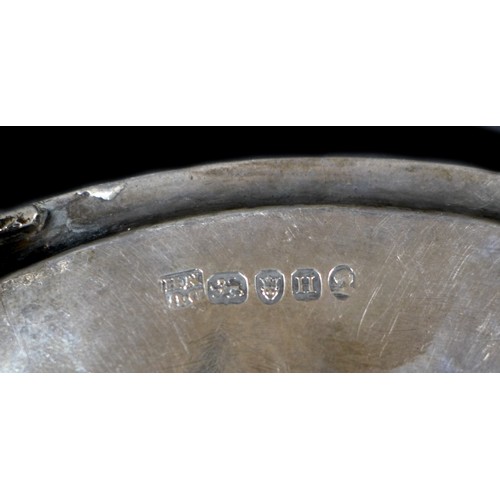 79 - A George III silver teapot stand, of oval form, with engraved wrigglework borders and central foliat... 