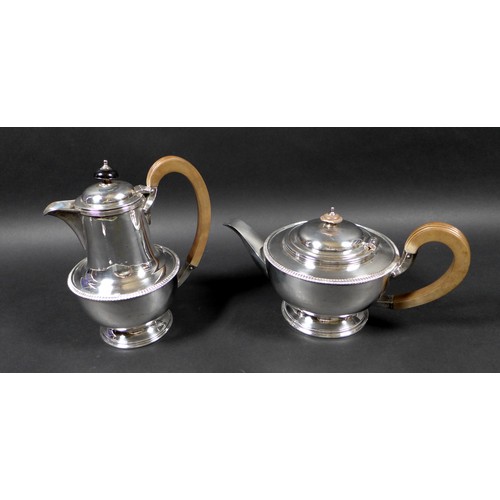 120 - A George V silver teapot and hot water pot, with gadrooned decoration, 13.5 and 19.5cm high, Cooper ... 