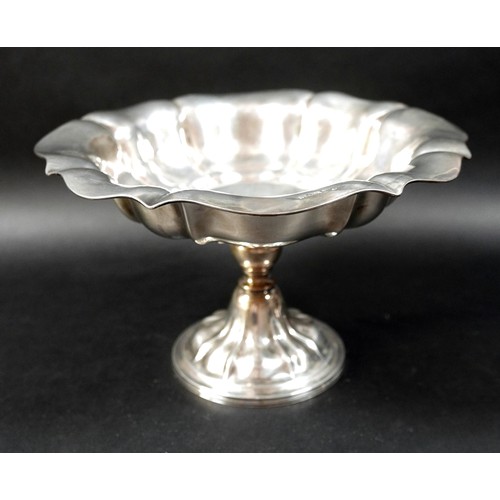 130 - A pair of Victorian silver pedestal bowls, each of lobed oval form raised on a stepped and shaped ci... 