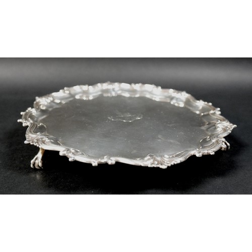 124 - A Victorian silver tray, of shaped circular form with Chippendale pie crust edge, central engraved a... 