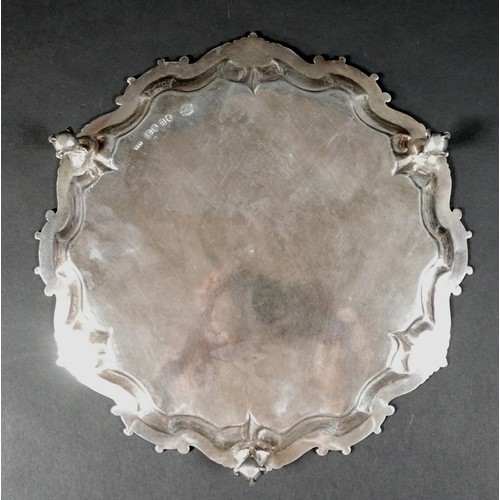 124 - A Victorian silver tray, of shaped circular form with Chippendale pie crust edge, central engraved a... 