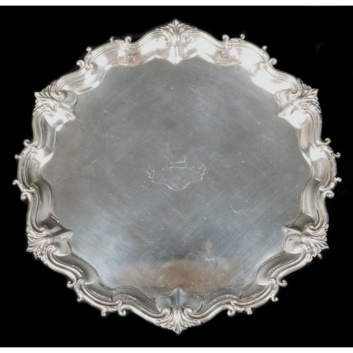 124 - A Victorian silver tray, of shaped circular form with Chippendale pie crust edge, central engraved a... 