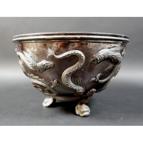 125 - An Edward VII Irish silver bowl, repoussé decorated with flying fish, plannished base, raised on thr... 