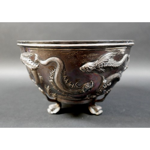 125 - An Edward VII Irish silver bowl, repoussé decorated with flying fish, plannished base, raised on thr... 