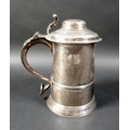 A George III silver lidded tankard, of tapering cylindrical form with moulded girdle, the domed lid ... 