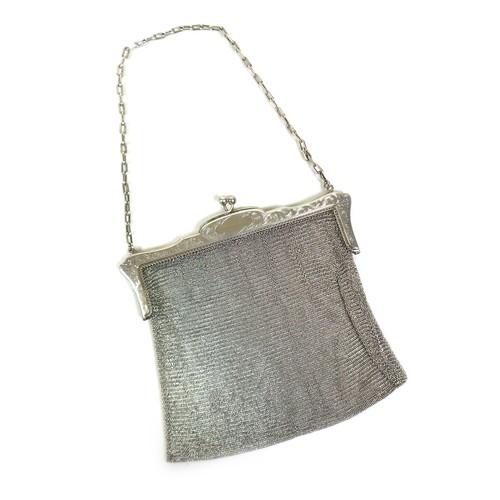 70 - An early 20th century silver ladies chainmail bag, floral engraved frame with chainmail link bag and... 