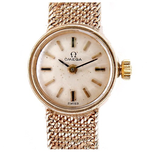 208 - An Omega 9ct gold lady's wristwatch, circa 1965, model 711.5730, with circular champagne dial, gold ... 