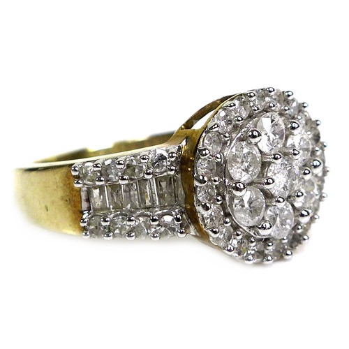 361 - A 9ct yellow gold and diamond ring, of target form with wide tapering shoulders, set centrally with ... 