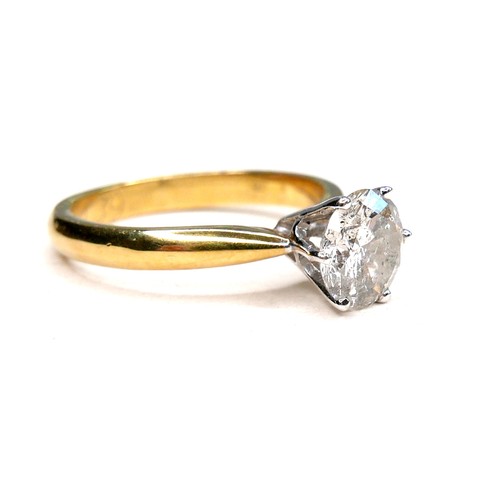 389 - An 18ct gold diamond solitaire ring, the round brilliant cut stone, 7.1mm diameter, 1.39ct, in a rai... 