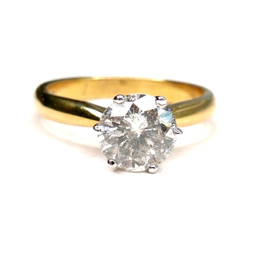 389 - An 18ct gold diamond solitaire ring, the round brilliant cut stone, 7.1mm diameter, 1.39ct, in a rai... 