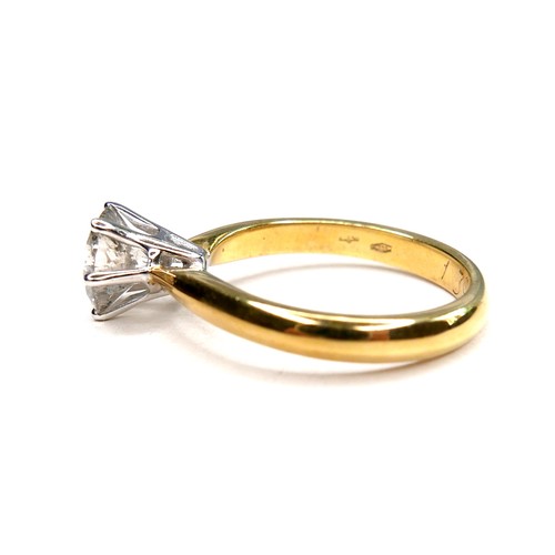 389 - An 18ct gold diamond solitaire ring, the round brilliant cut stone, 7.1mm diameter, 1.39ct, in a rai... 