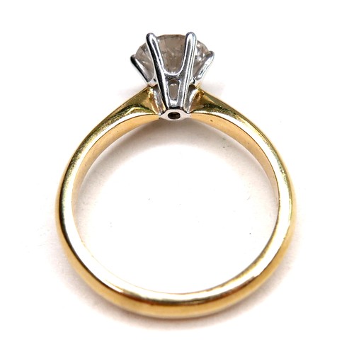 389 - An 18ct gold diamond solitaire ring, the round brilliant cut stone, 7.1mm diameter, 1.39ct, in a rai... 