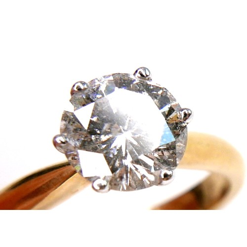 389 - An 18ct gold diamond solitaire ring, the round brilliant cut stone, 7.1mm diameter, 1.39ct, in a rai... 