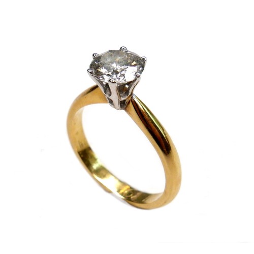 389 - An 18ct gold diamond solitaire ring, the round brilliant cut stone, 7.1mm diameter, 1.39ct, in a rai... 