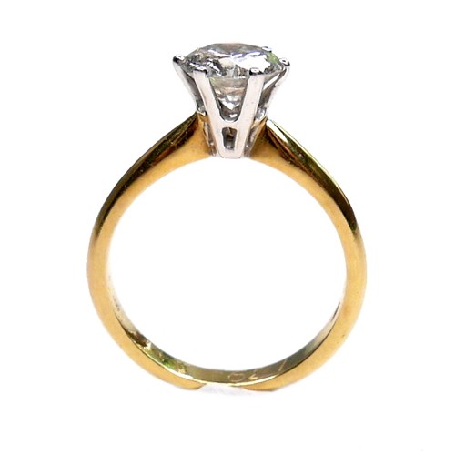 389 - An 18ct gold diamond solitaire ring, the round brilliant cut stone, 7.1mm diameter, 1.39ct, in a rai... 