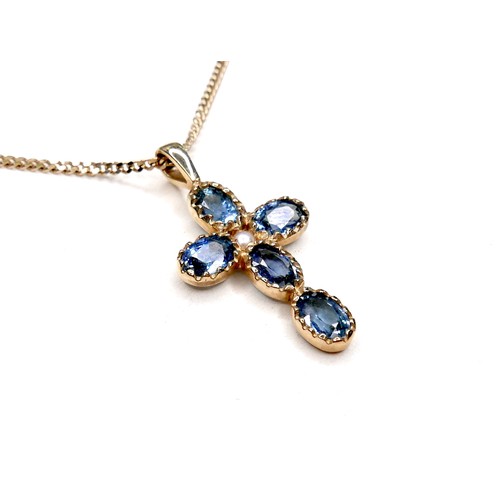 275 - A pale blue sapphire and pearl inlaid cross shaped pendant, set with a single pearl 18mm diameter, a... 