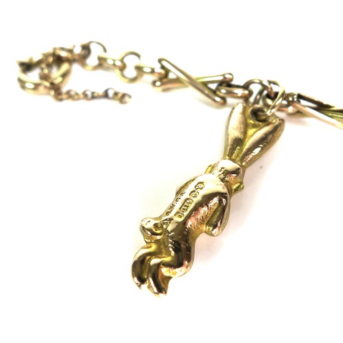 243 - A 9ct gold fancy link charm bracelet, suspended with four 9ct gold charms, all marked, 18.5cm long, ... 