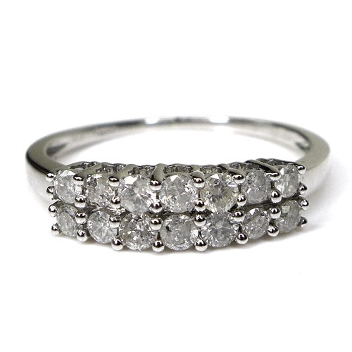 242 - A 9ct white gold and diamond ring, set with two rows of brilliant cut diamonds, size N/O, 1.9g.