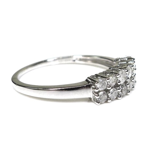 242 - A 9ct white gold and diamond ring, set with two rows of brilliant cut diamonds, size N/O, 1.9g.