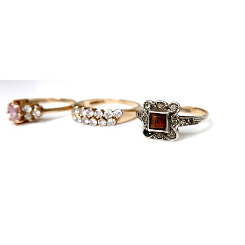 247 - A group of three 9ct gold rings, the first set with a marquise cut pink stone with cubic zirconia to... 