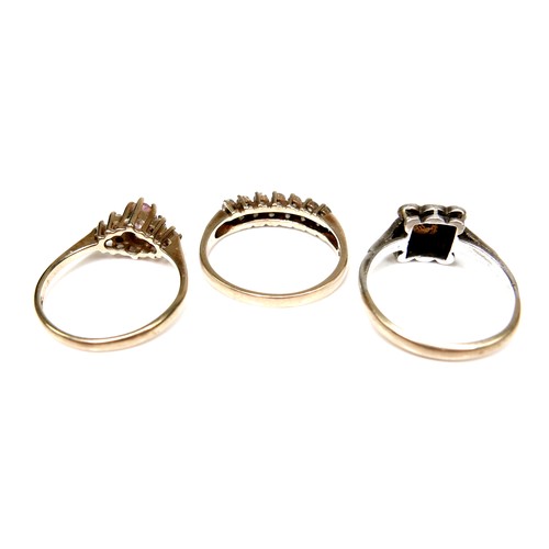 247 - A group of three 9ct gold rings, the first set with a marquise cut pink stone with cubic zirconia to... 