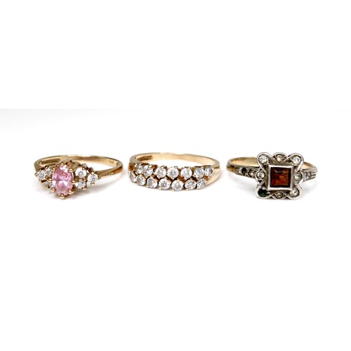 247 - A group of three 9ct gold rings, the first set with a marquise cut pink stone with cubic zirconia to... 