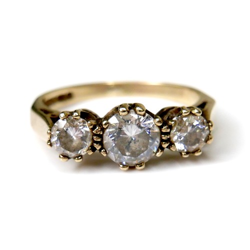 245 - A 9ct gold and three white stone ring, the central largest brilliant cut stone, 5.5 by 3.4mm, flanke... 