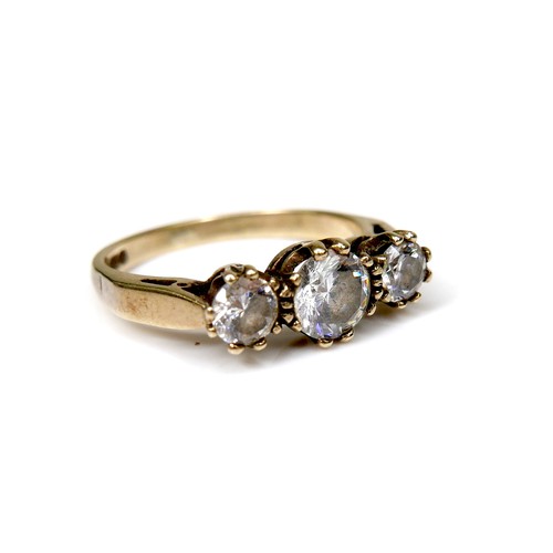 245 - A 9ct gold and three white stone ring, the central largest brilliant cut stone, 5.5 by 3.4mm, flanke... 