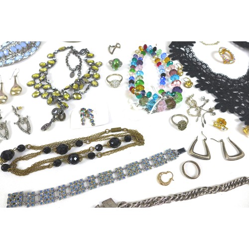 282 - A large collection of costume jewellery, including a silver bracelet with heart padlock charm, dress... 