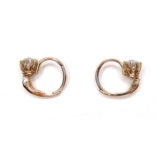 362 - A pair of diamond solitaire earrings, on fixed loop settings with hinged clasp, each brilliant cut s... 