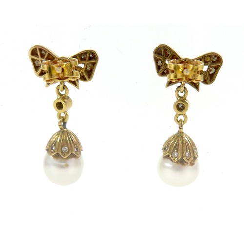 373 - A pair of 18ct gold and pearl drop earrings, early to mid 20th century, formed of bow design studs s... 