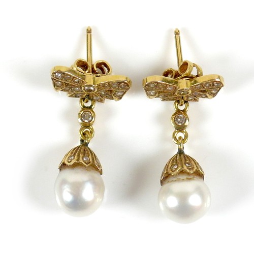 373 - A pair of 18ct gold and pearl drop earrings, early to mid 20th century, formed of bow design studs s... 