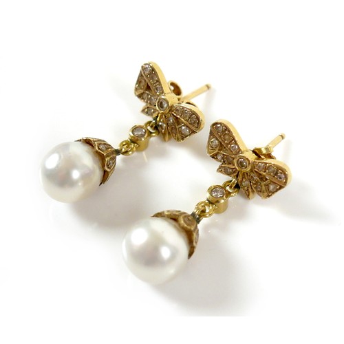 373 - A pair of 18ct gold and pearl drop earrings, early to mid 20th century, formed of bow design studs s... 