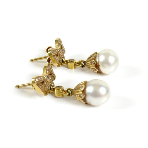 373 - A pair of 18ct gold and pearl drop earrings, early to mid 20th century, formed of bow design studs s... 