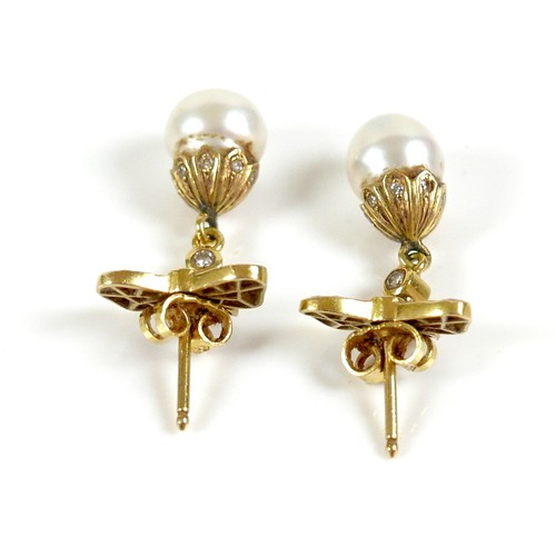 373 - A pair of 18ct gold and pearl drop earrings, early to mid 20th century, formed of bow design studs s... 