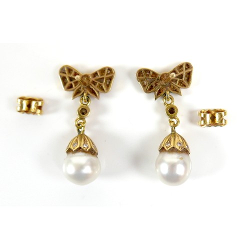 373 - A pair of 18ct gold and pearl drop earrings, early to mid 20th century, formed of bow design studs s... 